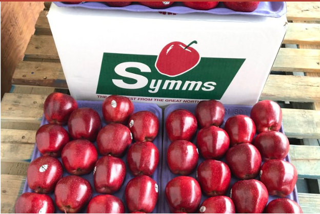 Box of Symms apples on a wooden pallet
