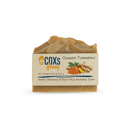 Bar of ginger turmeric soap with 'Cox's Honey' branding on a white background