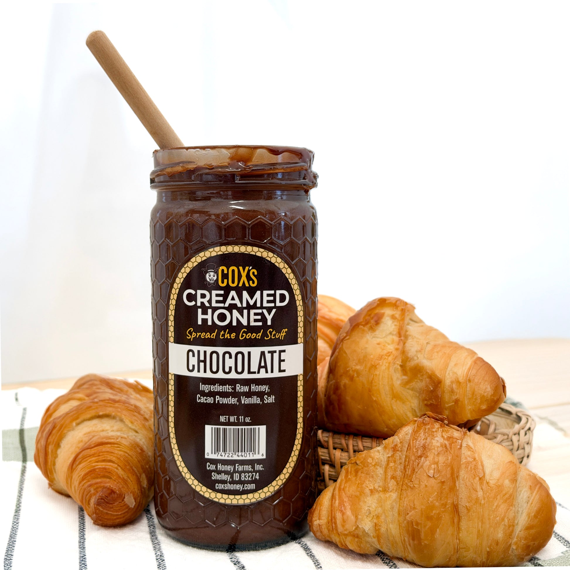 Jar of Cox's Creamed Honey Chocolate with croissants on a white background