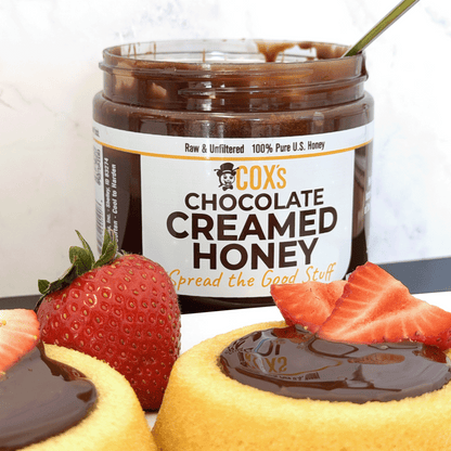 Coxs Honey 20 oz Chocolate Honey Spread on cake with strawberries