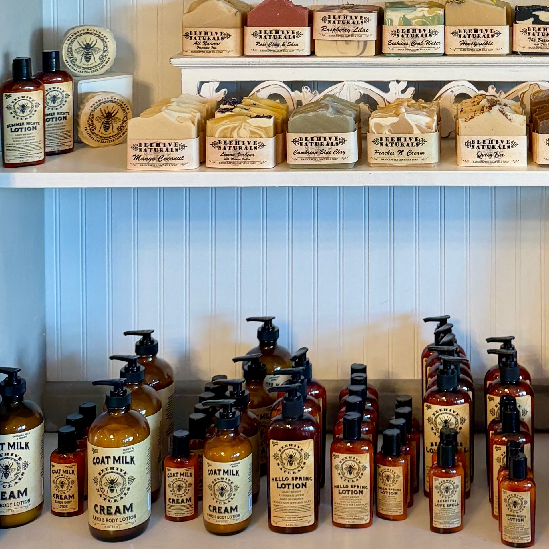 Display of various skincare products on shelves with a blue wall background.