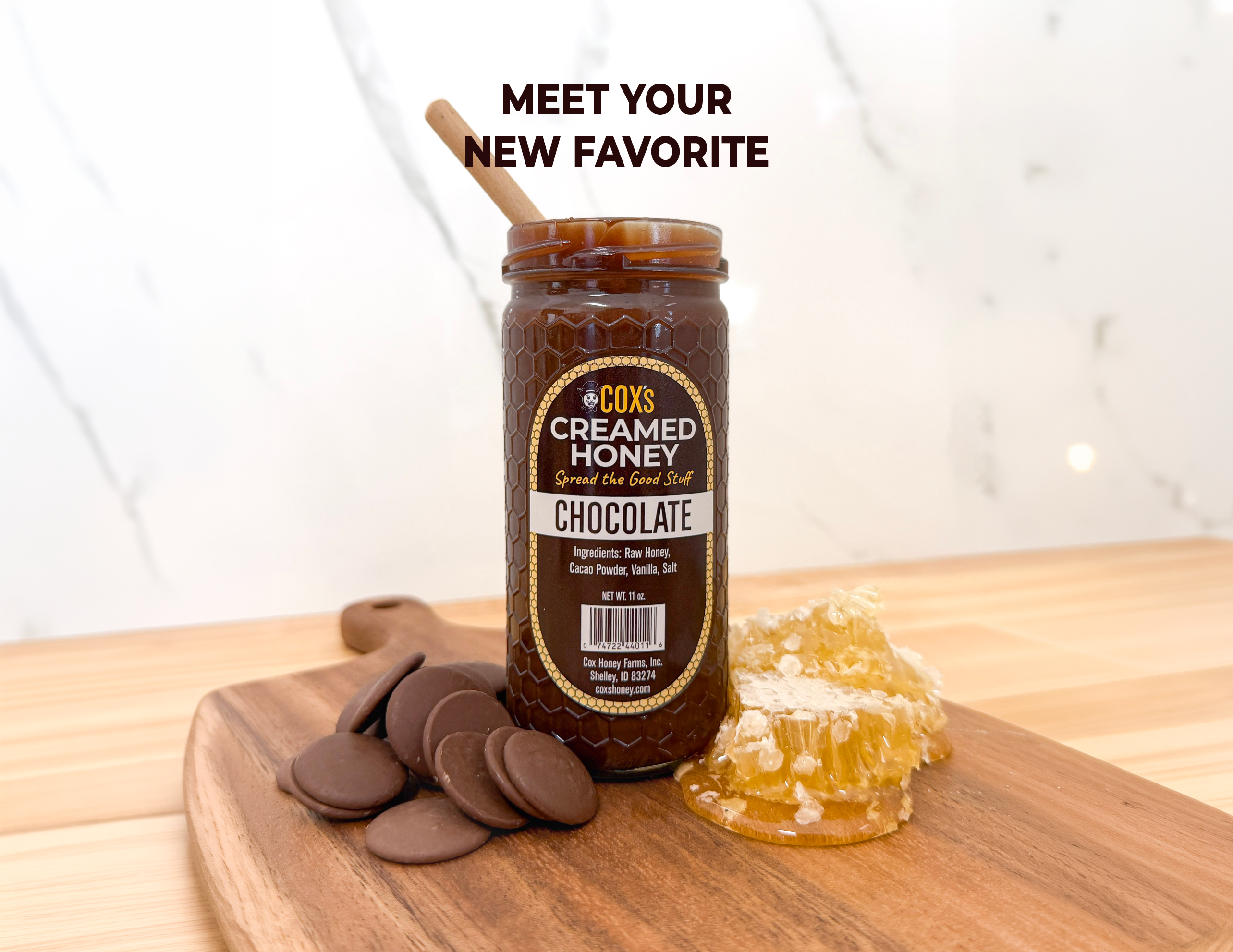 Jar of Cox's Creamed Honey Chocolate on a wooden surface with honeycomb and chocolate pieces.