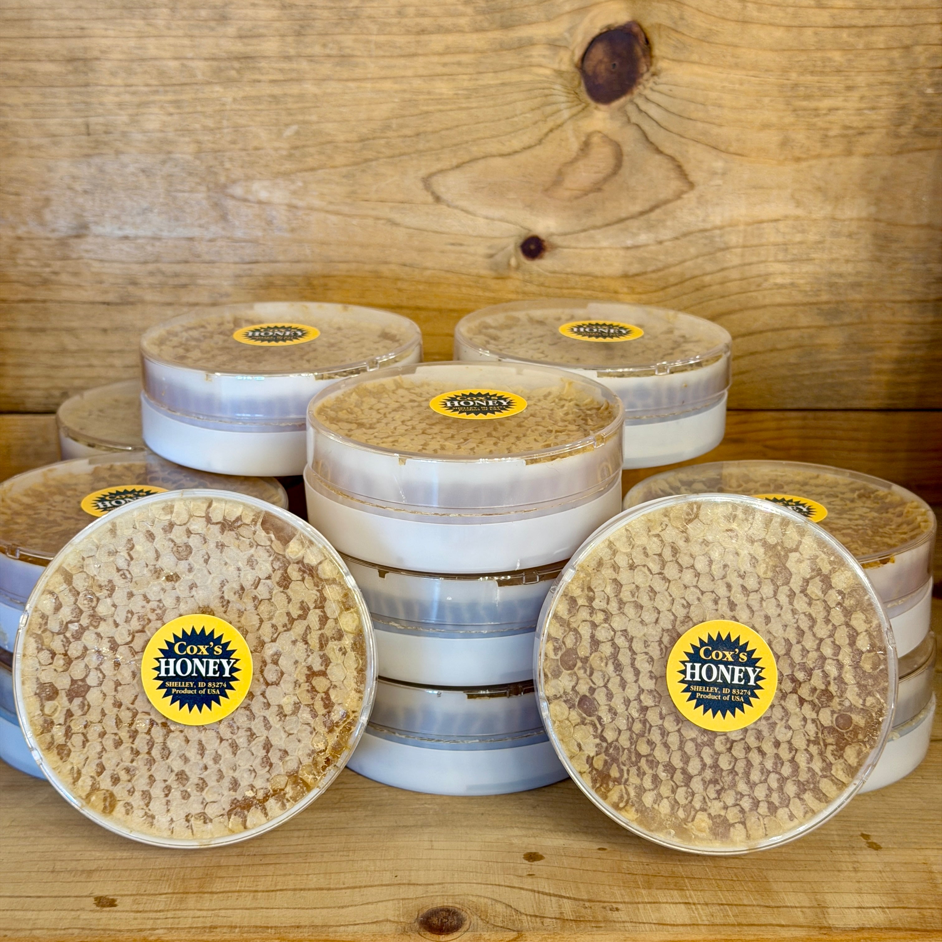 Honeycomb with visible labels on a wooden surface