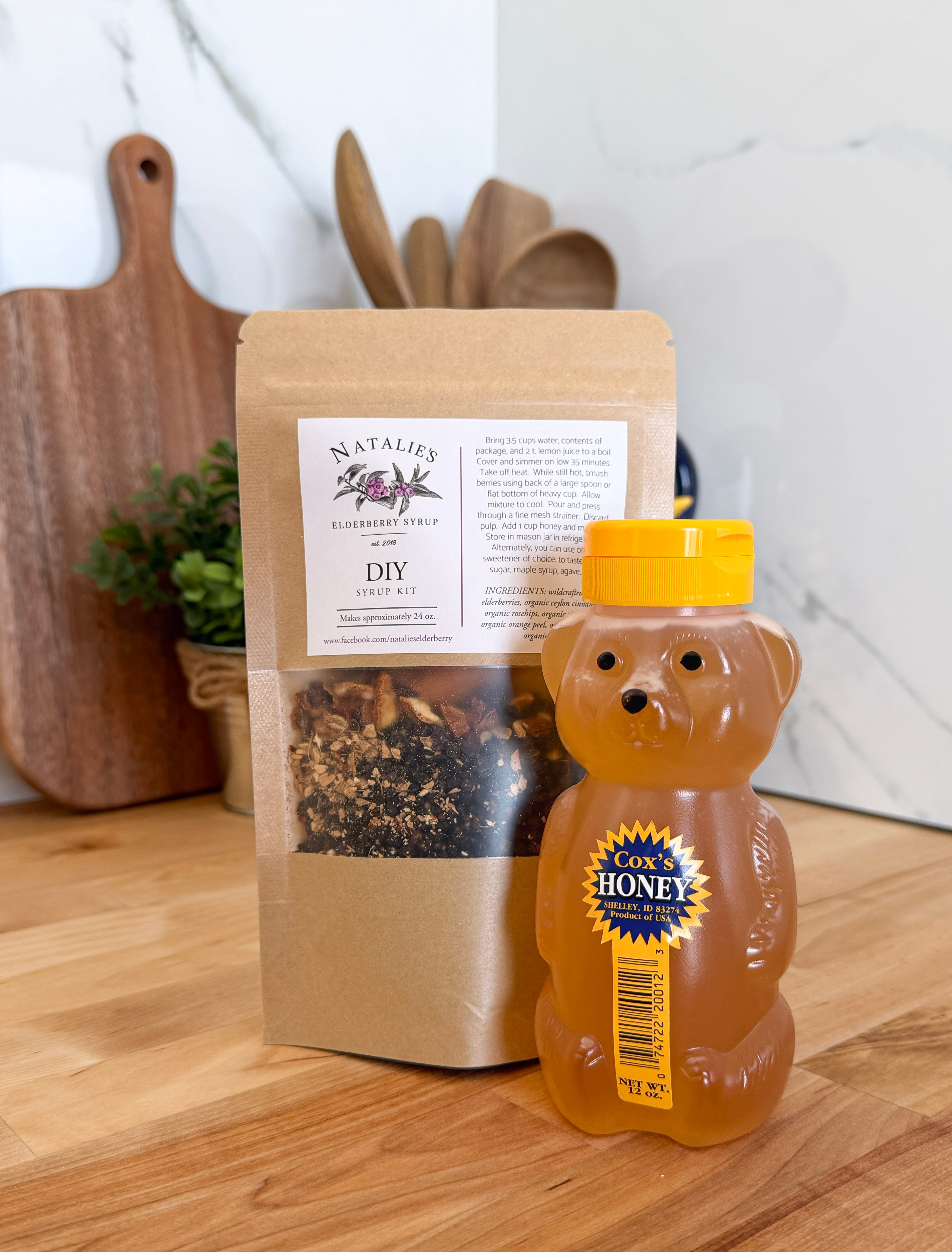 Natalie's Elderberry Syrup and Cox's Honey DIY Kit on a wood surface