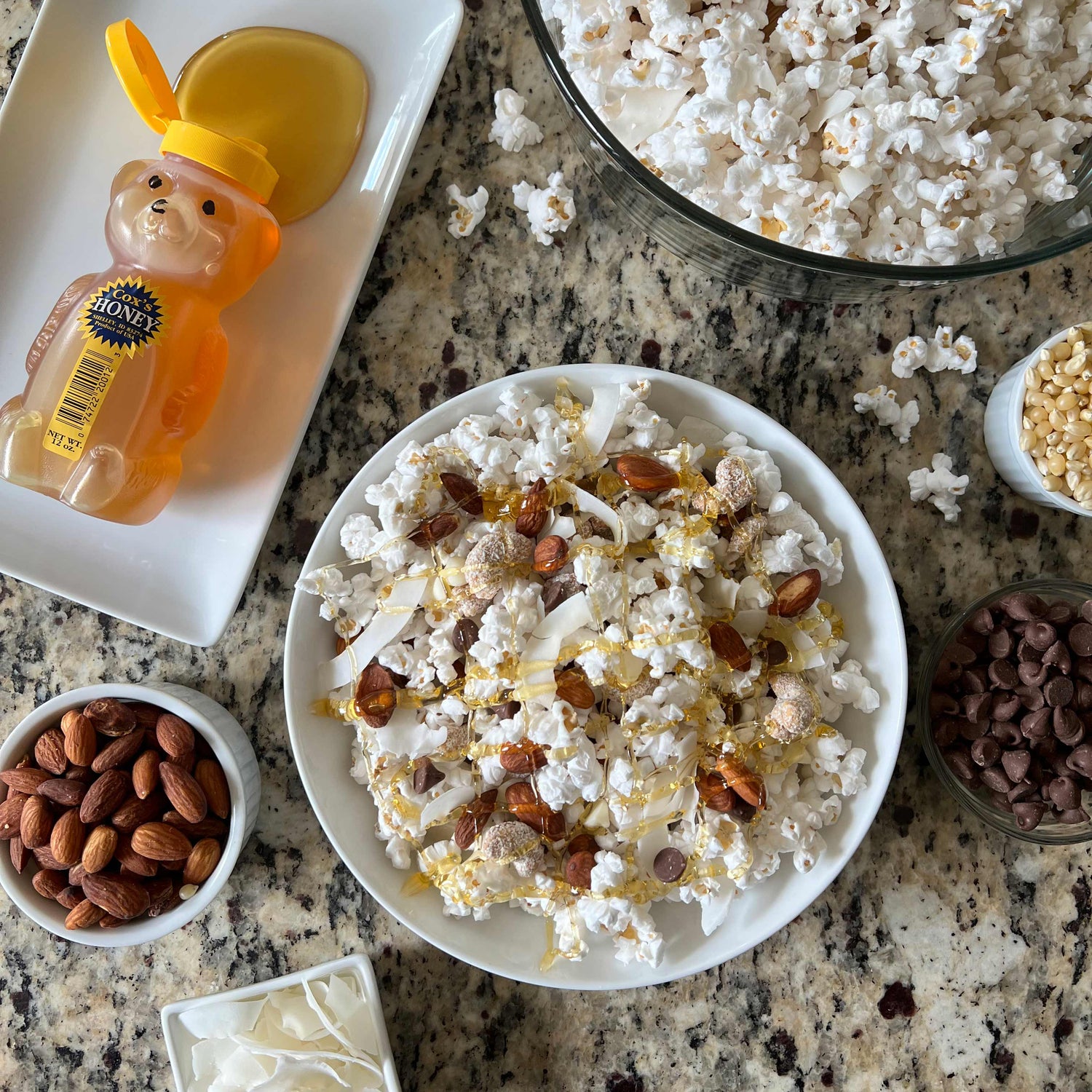 Coxs Honey Honey Butter Popcorn. Popcorn topped with nuts and honey. 
